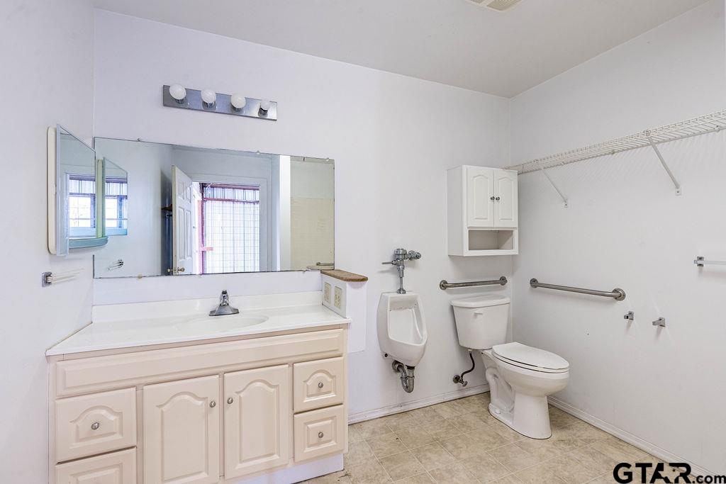 360 Anderson County Road Palestine, TX 75803 - Photo 28 of 41 a bathroom with a sink a toilet and a mirror