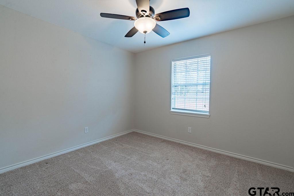 360 Anderson County Road Palestine, TX 75803 - Photo 3 of 41 an empty room with a window and a fan