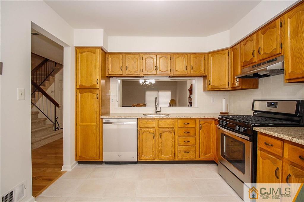 1705 Timber Oaks Road, Unit 1705 Edison, NJ 08820 - Photo 13 of 25 a kitchen with stainless steel appliances granite countertop a stove a sink and a refrigerator