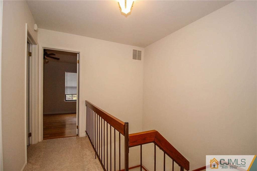 1705 Timber Oaks Road, Unit 1705 Edison, NJ 08820 - Photo 17 of 25 a view of a hallway with wooden floor