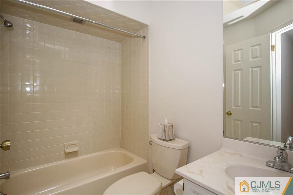 1705 Timber Oaks Road, Unit 1705 Edison, NJ 08820 - Photo 20 of 25 a bathroom with a sink a toilet and shower