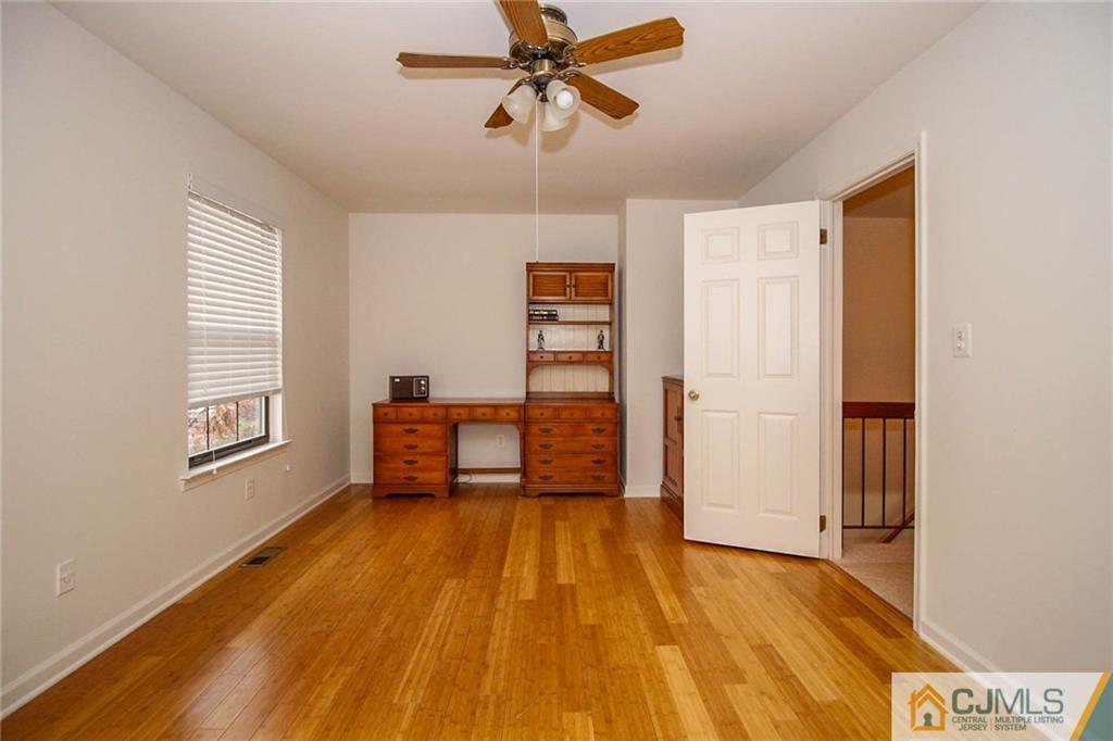 1705 Timber Oaks Road, Unit 1705 Edison, NJ 08820 - Photo 24 of 25 a living room with a bed furniture and a window
