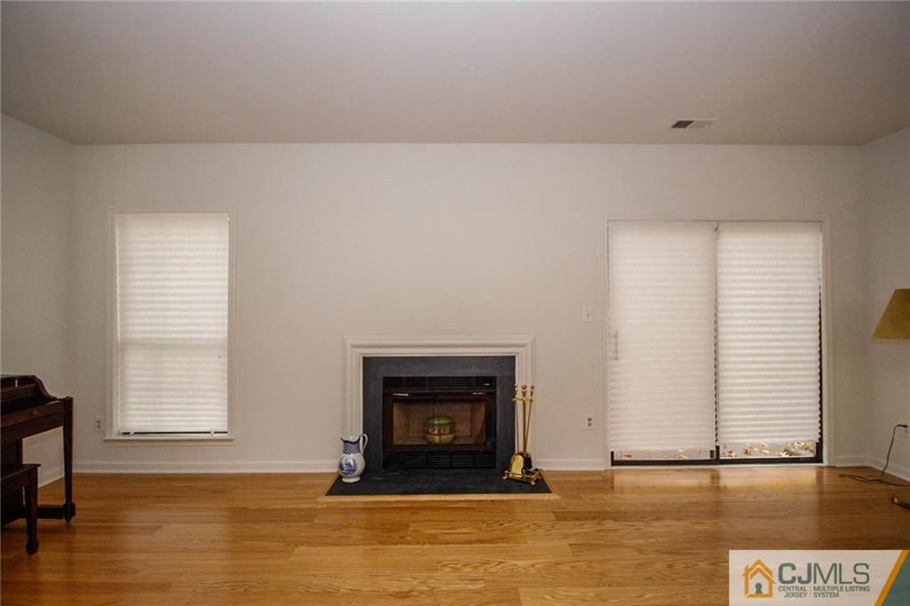1705 Timber Oaks Road, Unit 1705 Edison, NJ 08820 - Photo 5 of 25 a view of a livingroom with a fireplace and window