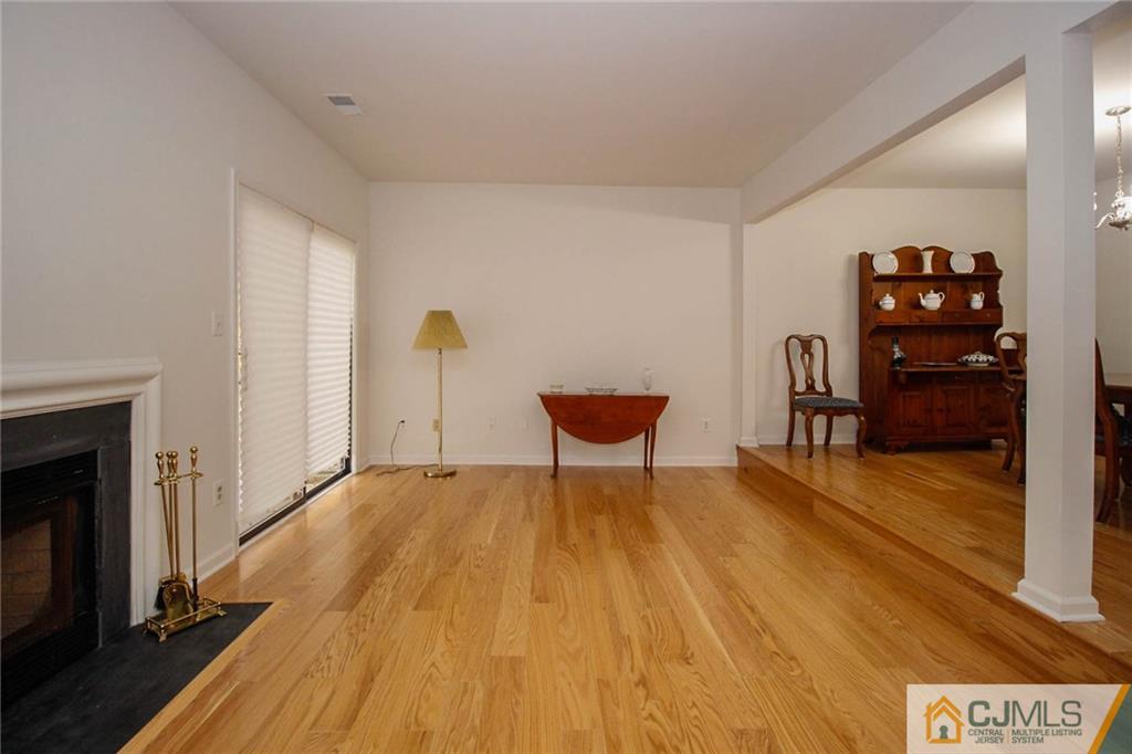 1705 Timber Oaks Road, Unit 1705 Edison, NJ 08820 - Photo 7 of 25 a view of a livingroom with wooden floor and a fireplace