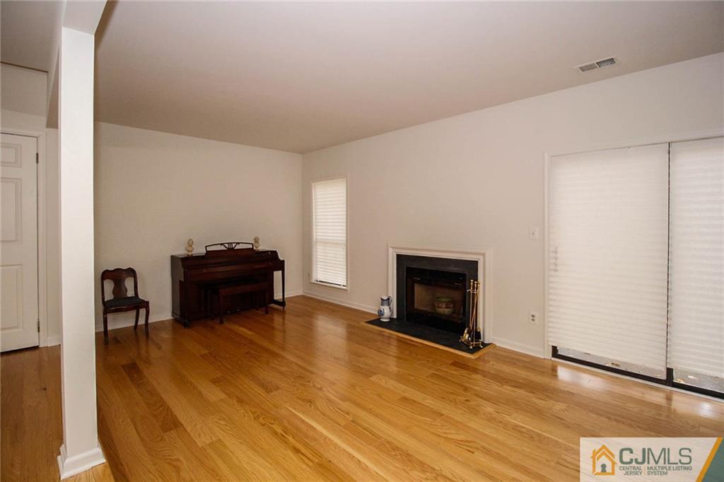 1705 Timber Oaks Road, Unit 1705 Edison, NJ 08820 - Photo 9 of 25 a room with furniture and a fireplace