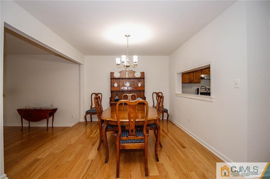 1705 Timber Oaks Road, Unit 1705 Edison, NJ 08820 - Photo 10 of 25 a view of a dining room with furniture and wooden floor