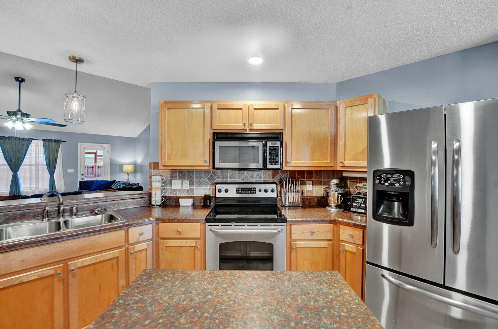 103 Citadel Lane Crestview, FL 32539 - Photo 13 of 41 a kitchen with stainless steel appliances granite countertop a stove top oven a sink and a refrigerator