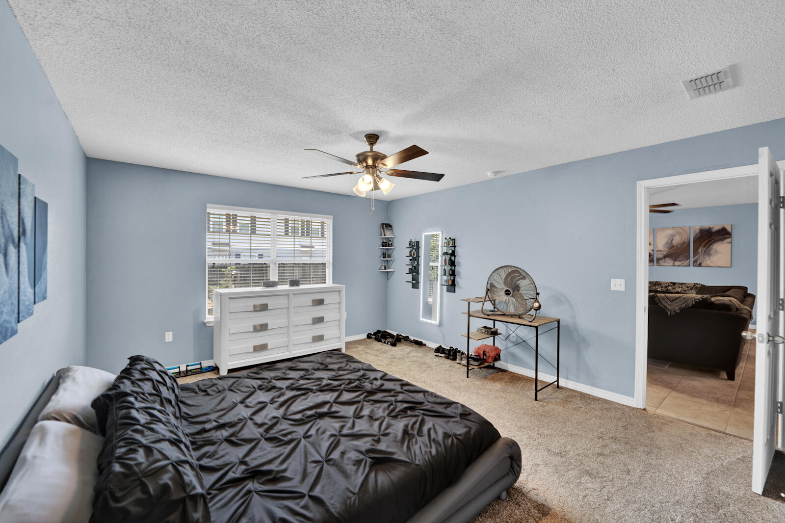 103 Citadel Lane Crestview, FL 32539 - Photo 15 of 41 a bedroom with a bed and a chandelier
