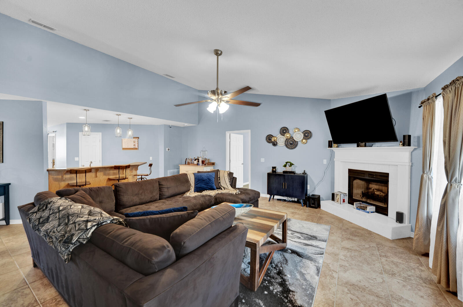 103 Citadel Lane Crestview, FL 32539 - Photo 3 of 41 a living room with furniture a fireplace and a flat screen tv