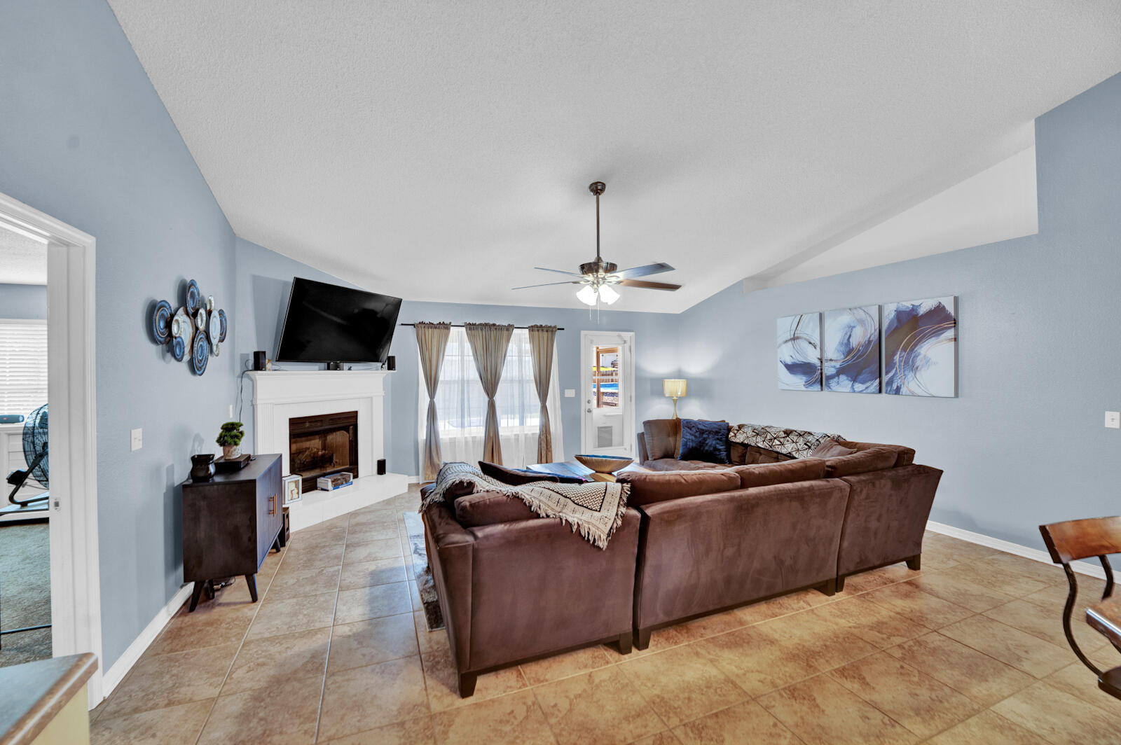 103 Citadel Lane Crestview, FL 32539 - Photo 8 of 41 a living room with furniture a fireplace and a flat screen tv