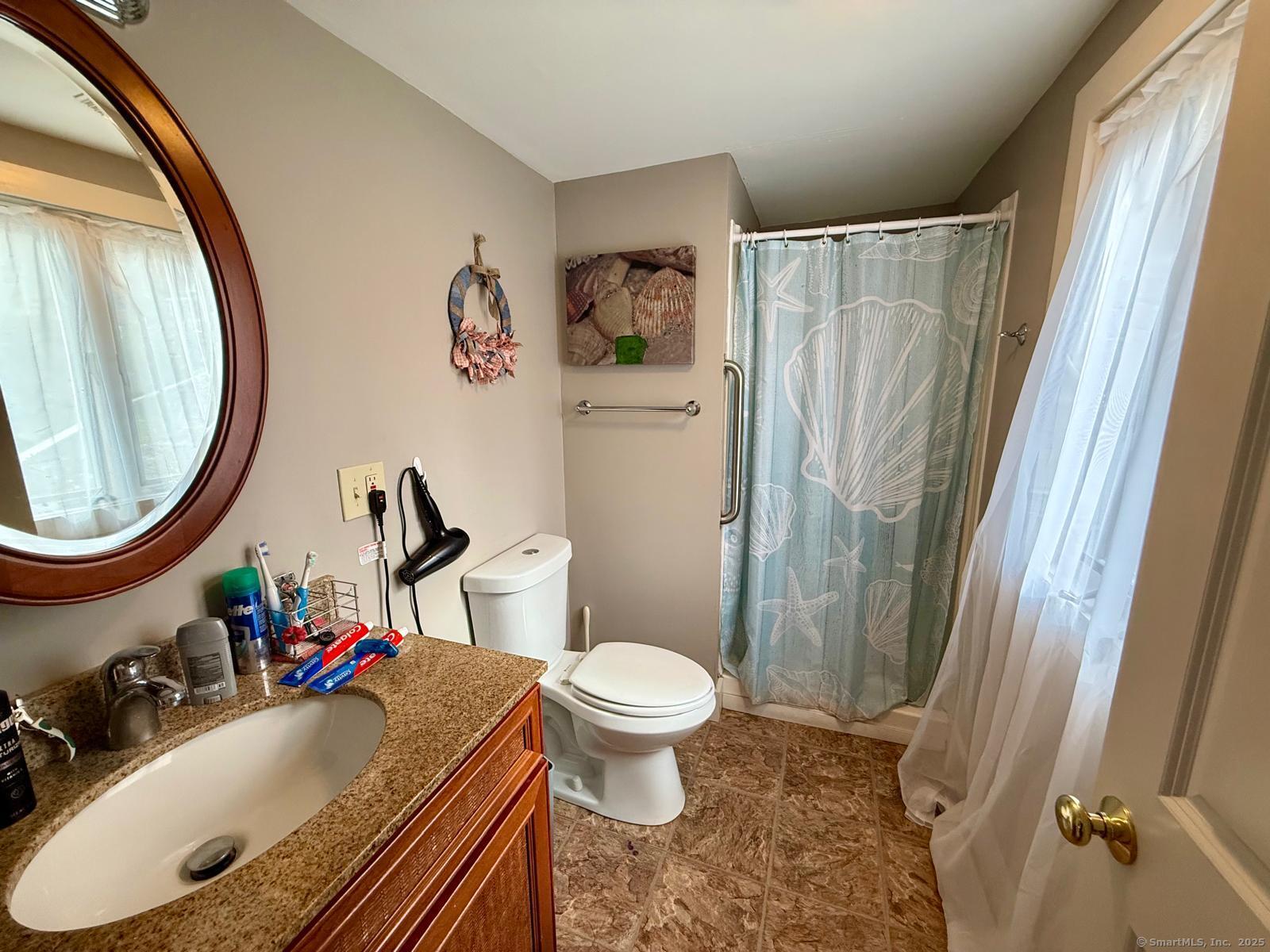 21 Boughton Road Old Lyme, CT 06371 - Photo 13 of 21 a bathroom with a sink toilet and a mirror