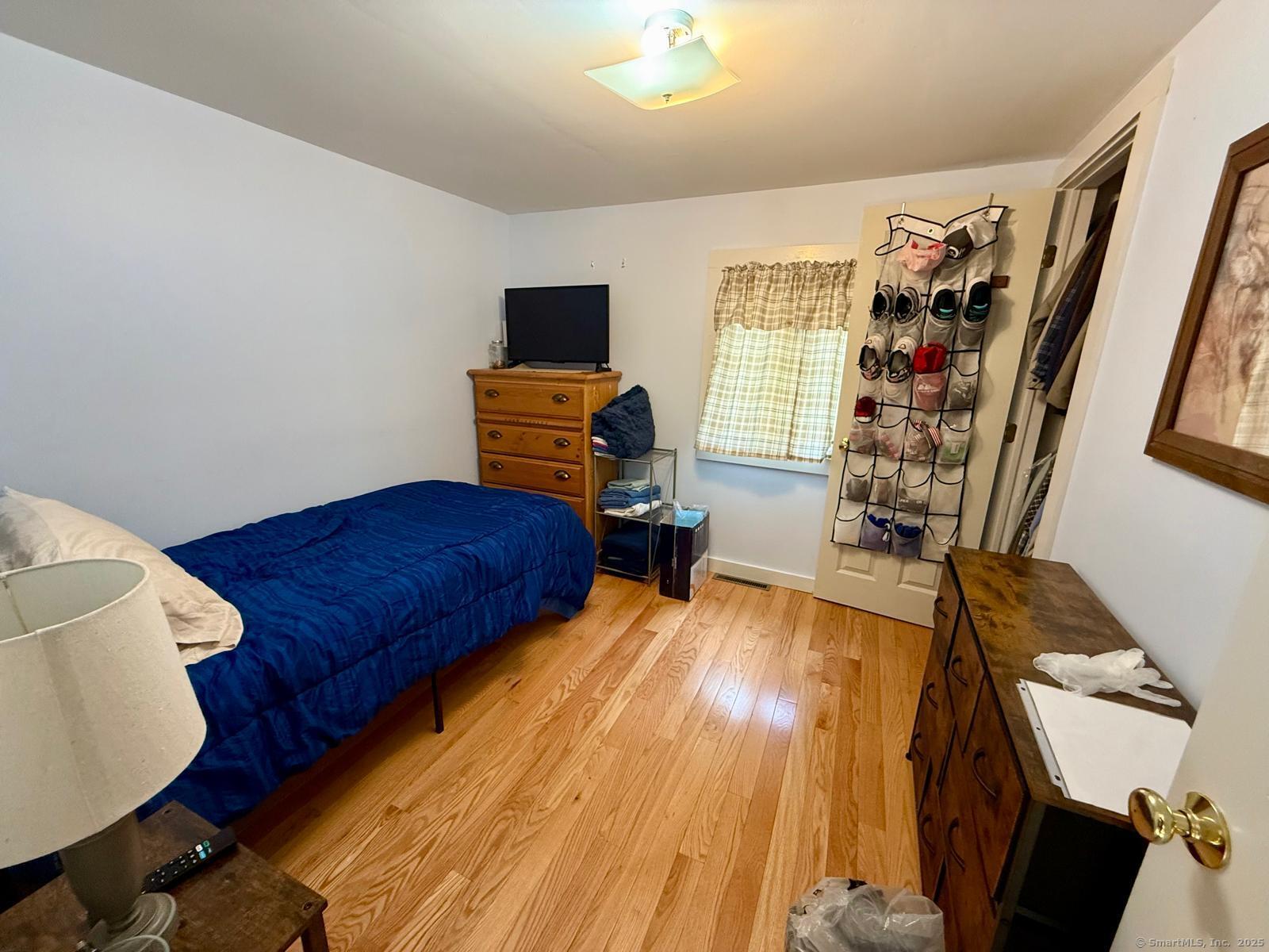 21 Boughton Road Old Lyme, CT 06371 - Photo 14 of 21 a bedroom with furniture and a wooden floor