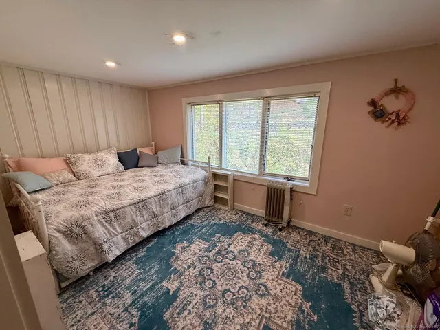 a bedroom with a bed and a window