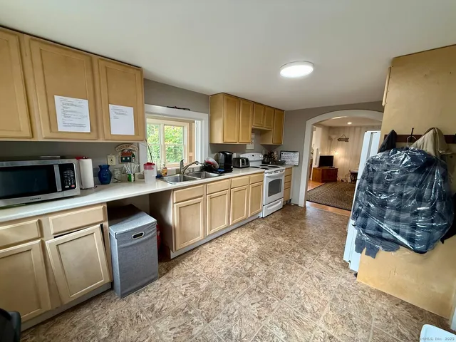 a kitchen with a sink stove and cabinets