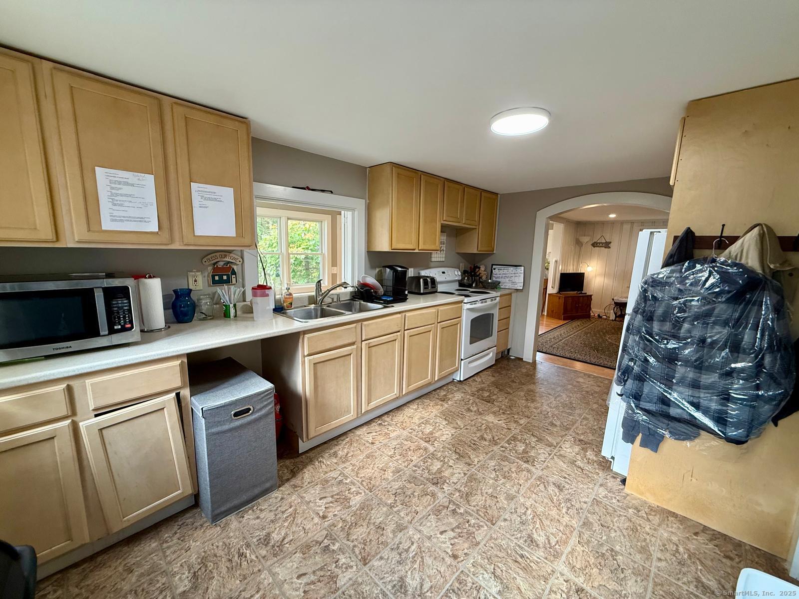 21 Boughton Road Old Lyme, CT 06371 - Photo 5 of 21 a kitchen with a sink stove and cabinets