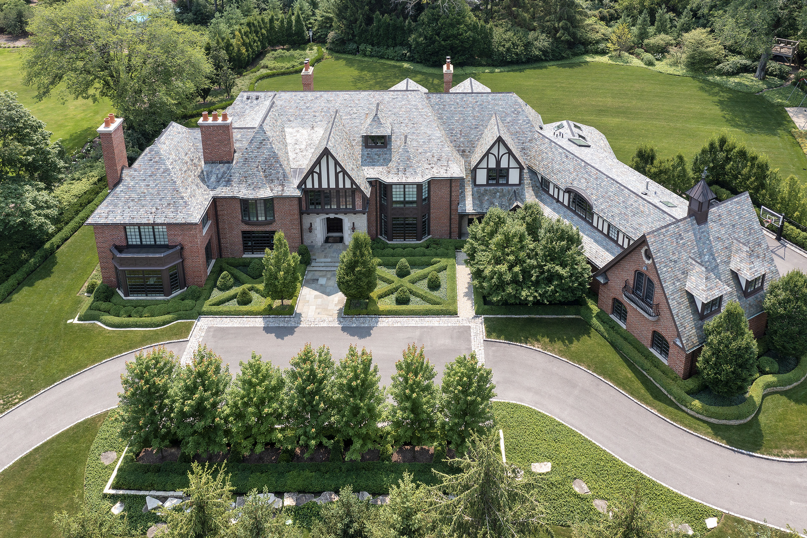 an aerial view of a house with a big yard and potted plants