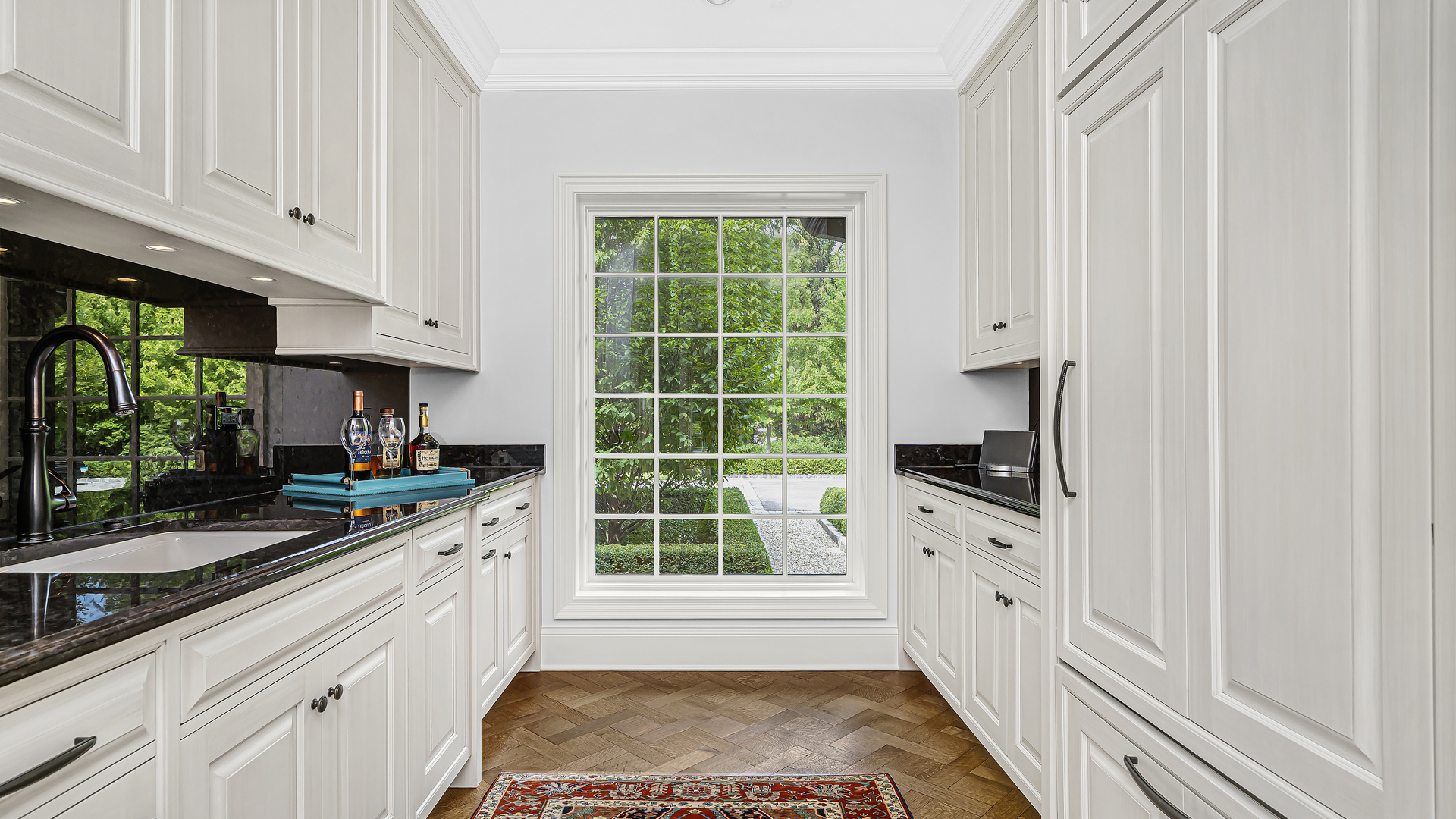 37 Woodley Road Winnetka, IL 60093 - Photo 30 of 66 a kitchen with white cabinets and a window