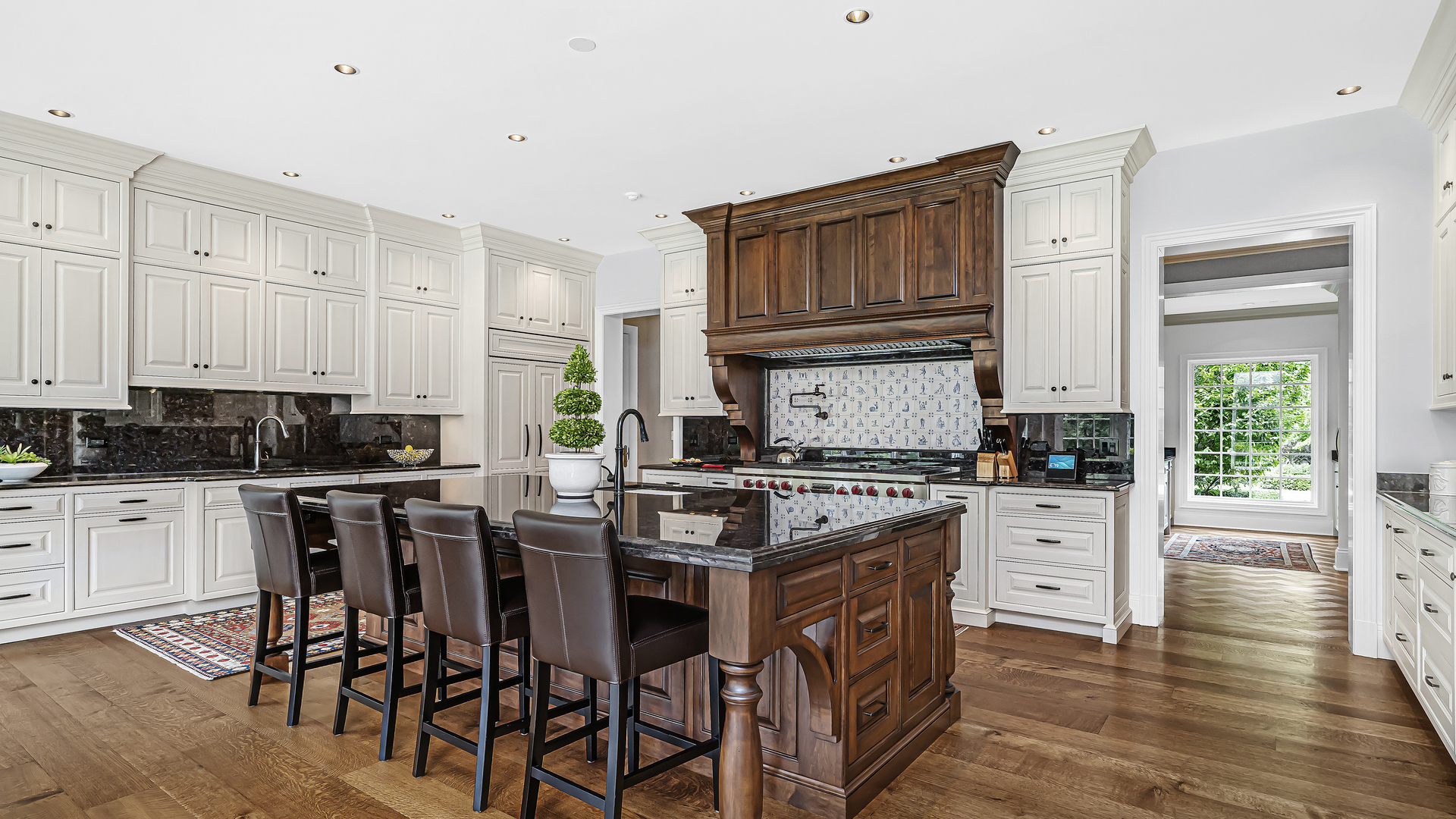 37 Woodley Road Winnetka, IL 60093 - Photo 35 of 66 a kitchen with stainless steel appliances granite countertop a stove top oven a sink a dining table and chairs with wooden floor