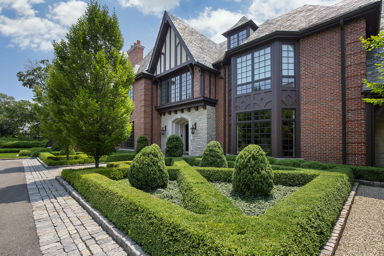 37 Woodley Road Winnetka, IL 60093 - Photo 6 of 66 a view of a house with brick walls plants and large tree