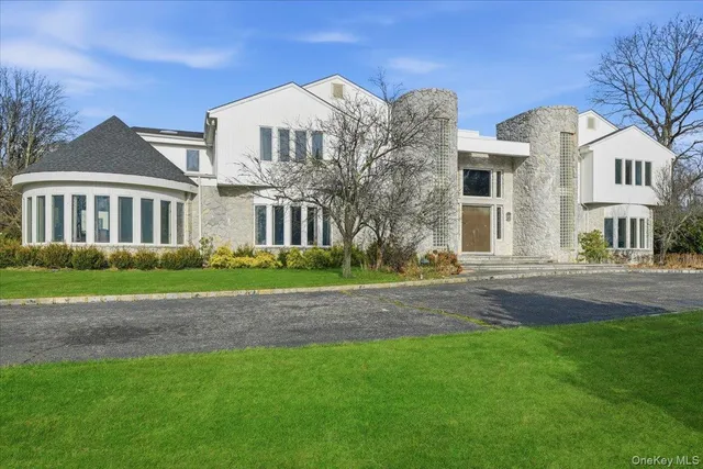 a view of a big house with a big yard and large trees