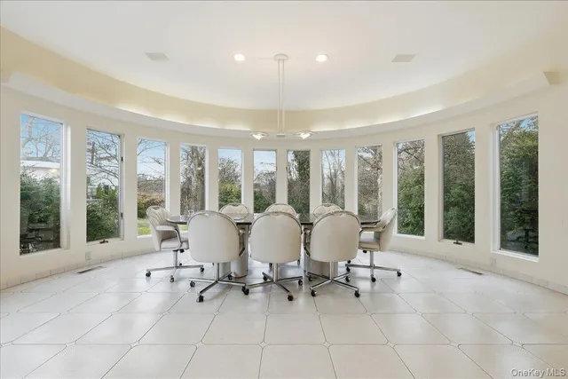 a living room with furniture and floor to ceiling windows