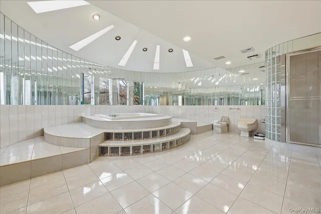 a view of a large building with a swimming pool and sitting space