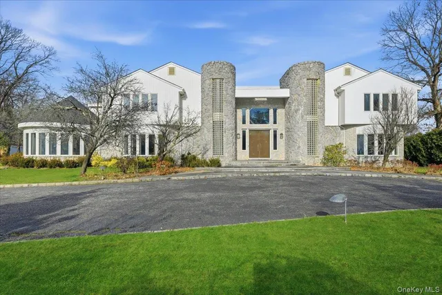 a front view of a house with a garden