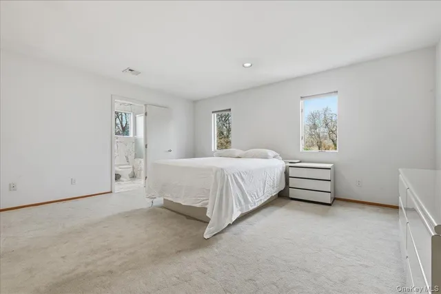 a bed room with a bed and a night stand