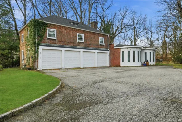a front view of a house with a garden and yard