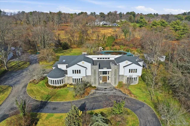 a view of a house with a swimming pool and a yard