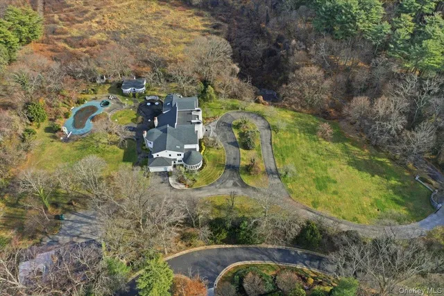 an aerial view of residential house with outdoor space and trees