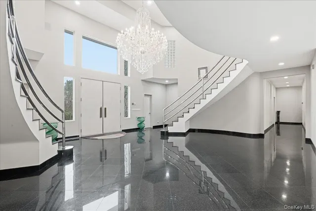 a view of entryway and hall with wooden floor