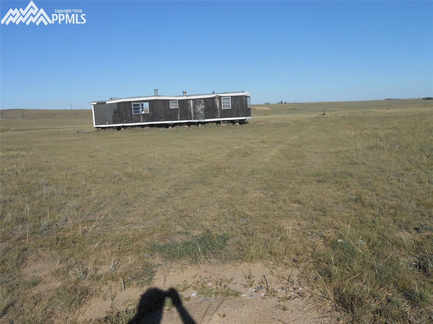 12805 Berridge Road Calhan, CO 80808 - Photo 1 of 2 This old mobile is on the property. A nicer building spot is located to the left.