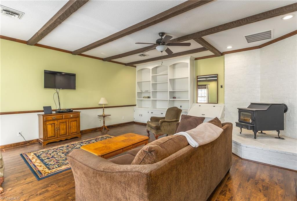 4501 Millis Road Greensboro, NC 27407 - Photo 4 of 16 Great Room with Built in Shelves and Wood Burning Stove