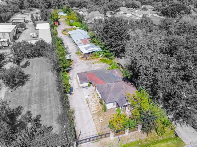an aerial view of a house with a yard