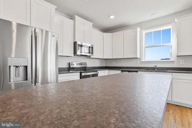 a living room with furniture dining area and a window