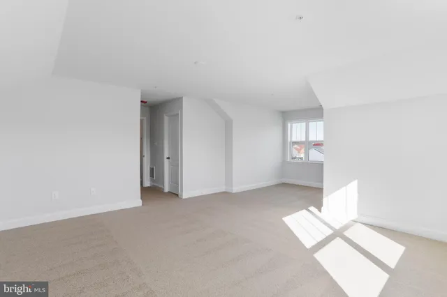 a bathroom with a granite countertop sink a toilet and a mirror