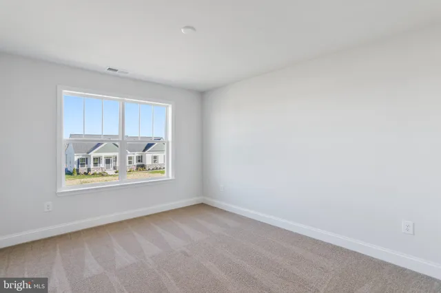 a view of a white house with a big yard and large trees