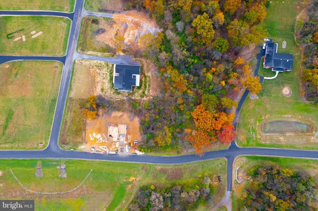 a view of kitchen with cabinets wooden floor and stainless steel appliances