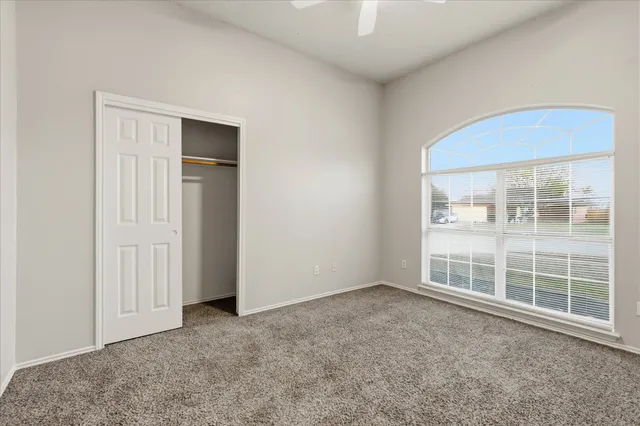 an empty room with closet area