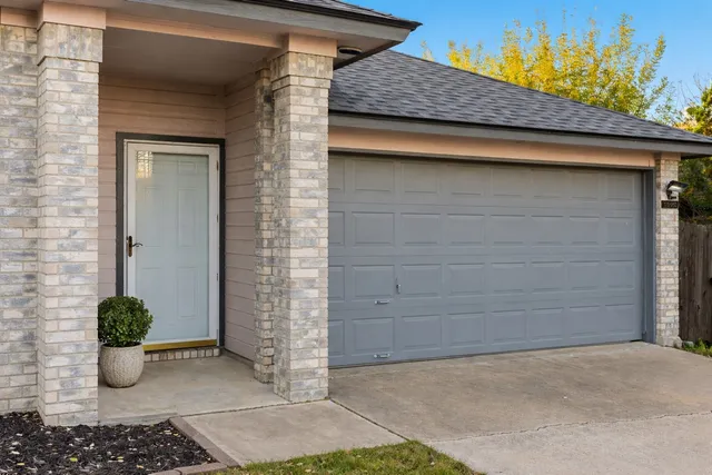 a couple of potted plant in front of door