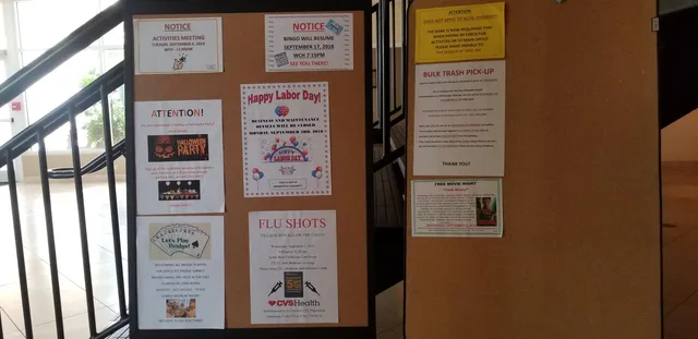 a view of kitchen with furniture and refrigerator
