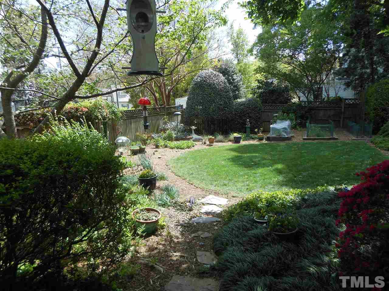 2404 White Oak Road Raleigh, NC 27609 - Photo 14 of 23 a backyard of a house with lots of green space