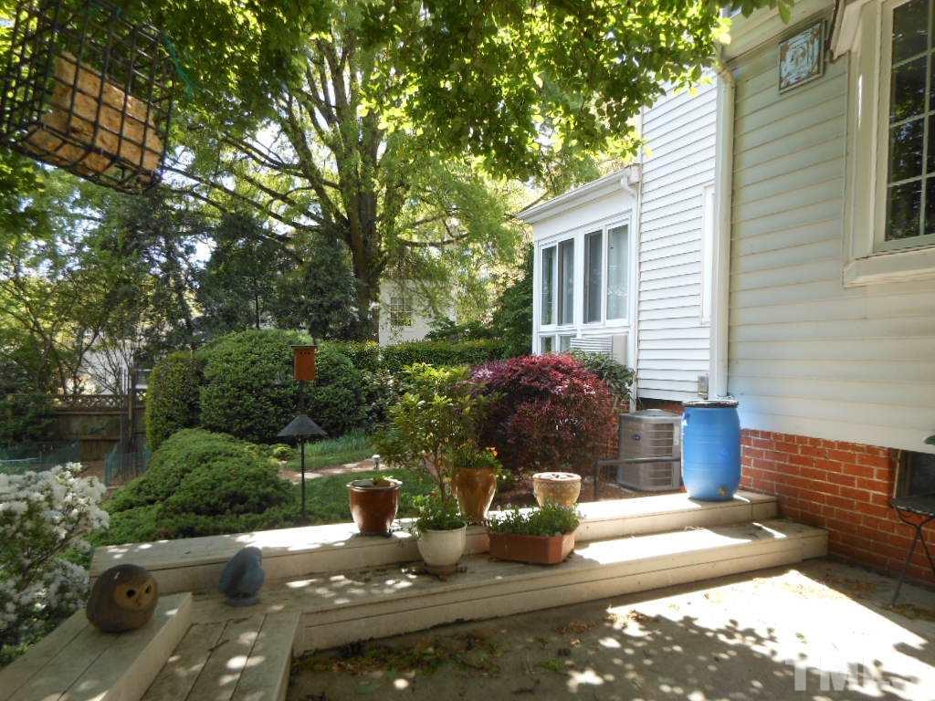 2404 White Oak Road Raleigh, NC 27609 - Photo 19 of 23 a view of a house with backyard sitting area and garden