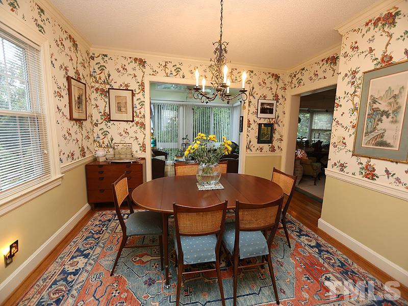 2404 White Oak Road Raleigh, NC 27609 - Photo 7 of 23 a dining room with furniture a chandelier and wooden floor