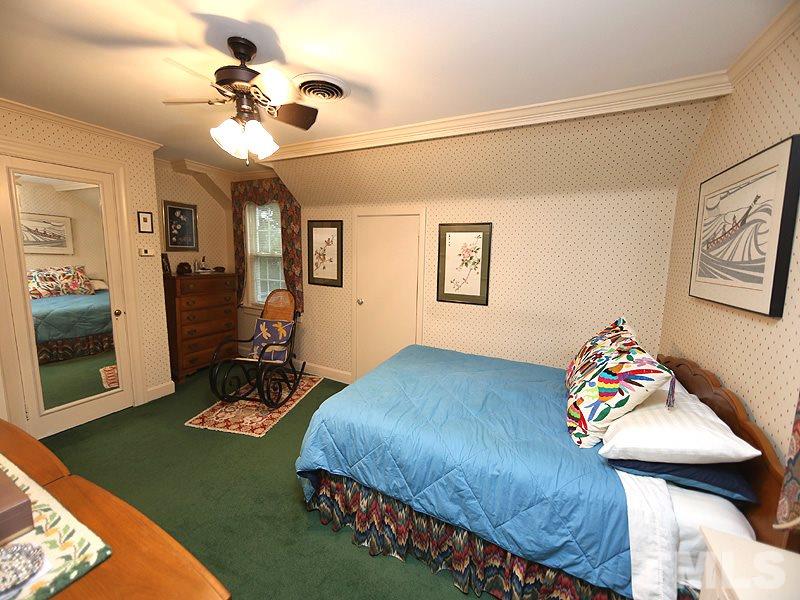 2404 White Oak Road Raleigh, NC 27609 - Photo 9 of 23 a bedroom with a bed and a chandelier
