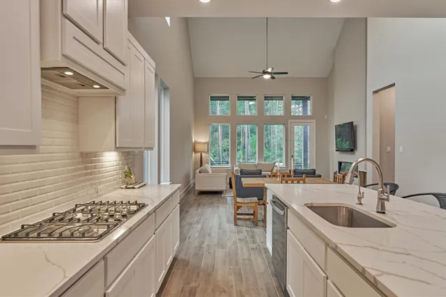 a kitchen with a sink stove and cabinets