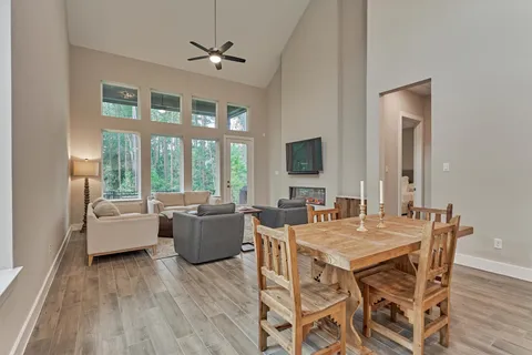 a view of a dining room with furniture and a floor to ceiling window