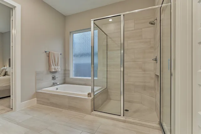 a bathroom with a shower and a bath tub