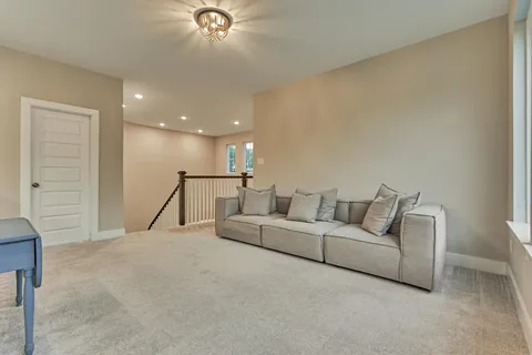 a living room with furniture and a ceiling fan
